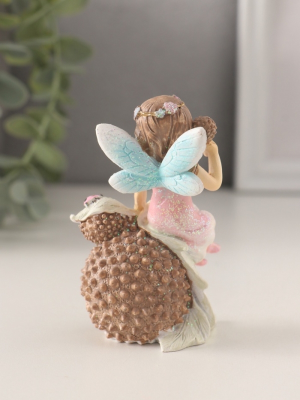 Сувенир полистоун "Девочка-фея в розовом платье на фрукте с божьей коровкой" 6,5х5х9 см